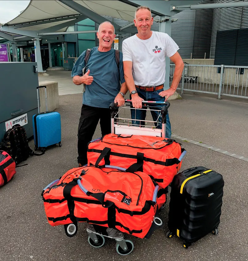 Packed and ready to go! Andy Pinder (left) and Tony Darbyshire en route to Sumatra. The orange bags were full of kit donated by supporters.